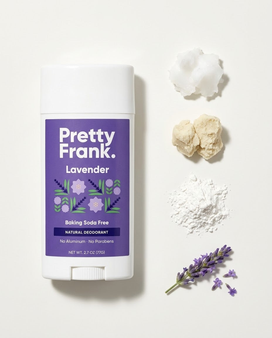 Pretty Frank Lavender baking soda free deodorant stick next to its ingredients laid out in a row: coconut oil, shea butter, arrowroot powder and a sprig of lavender